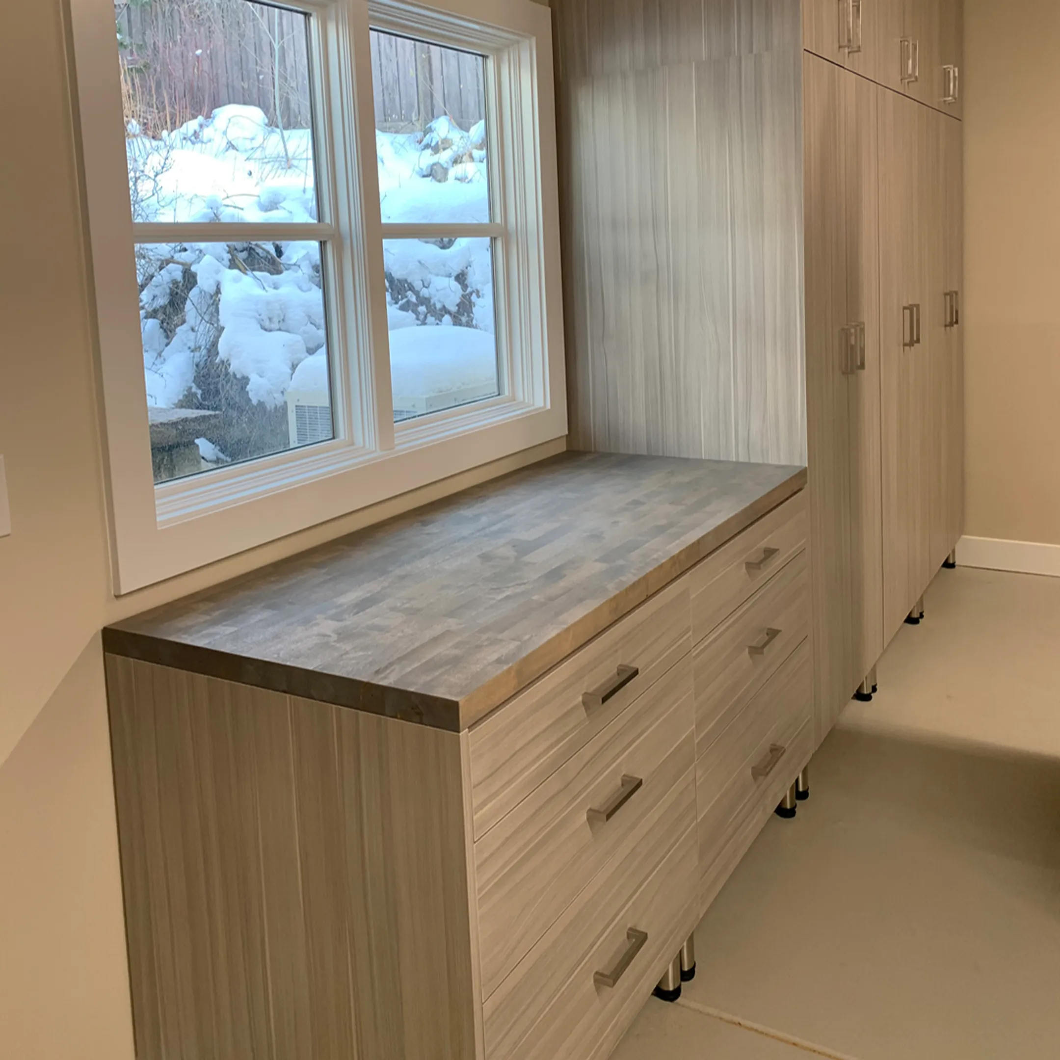 Organized garage with custom cabinets and workbench