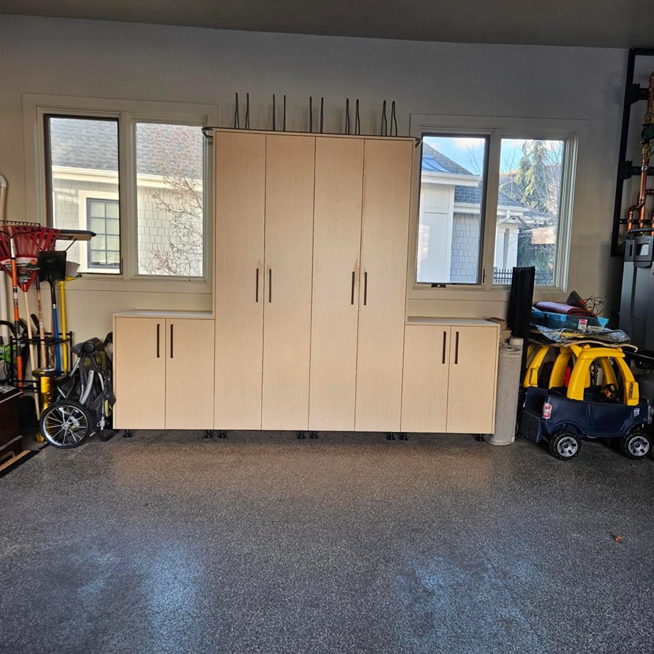 Installer measuring garage wall for storage panels