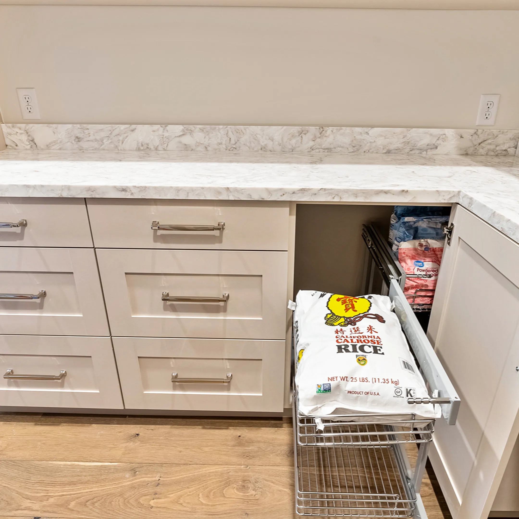Cabinet installer measuring a kitchen wall