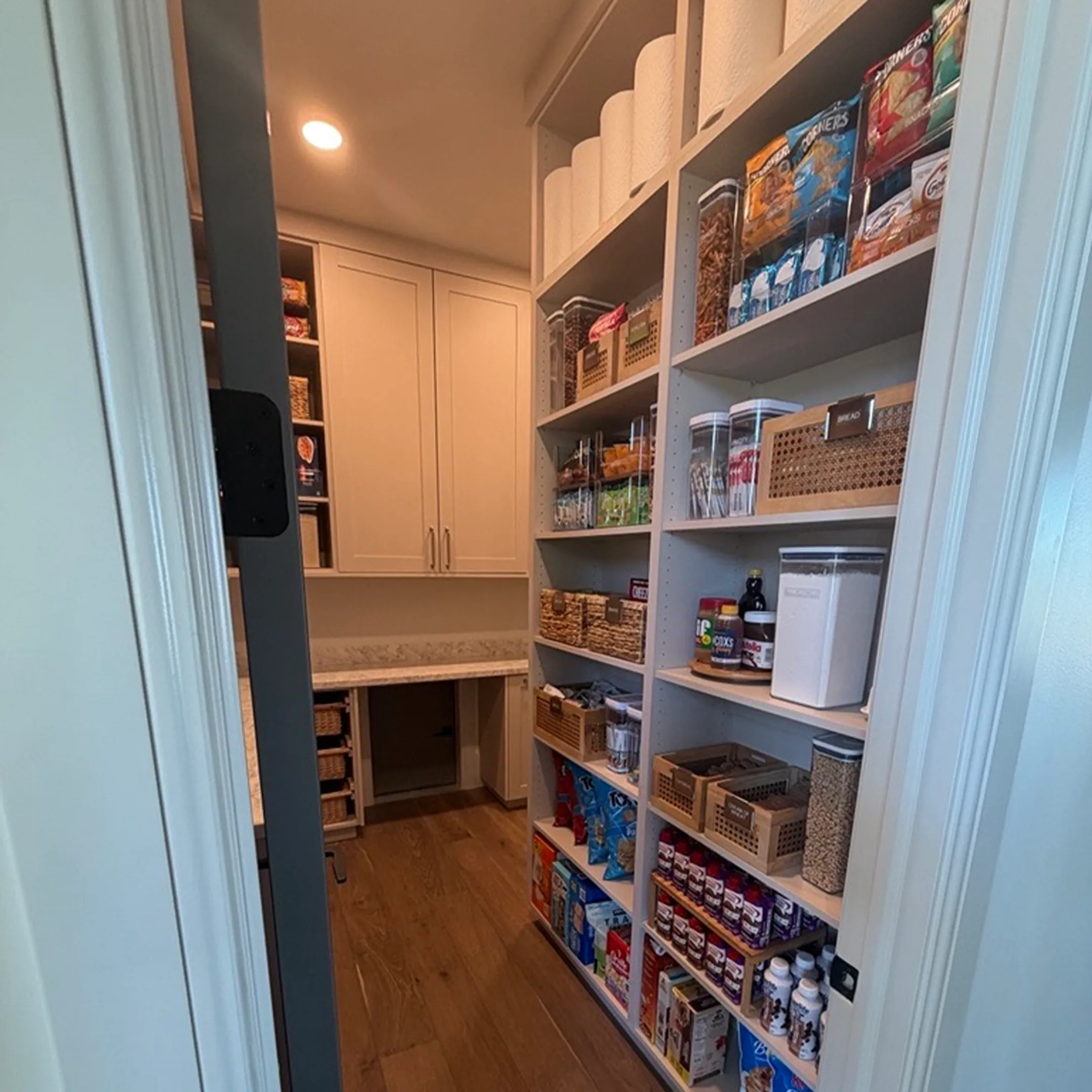 Designer reviewing custom cabinet plans with homeowners