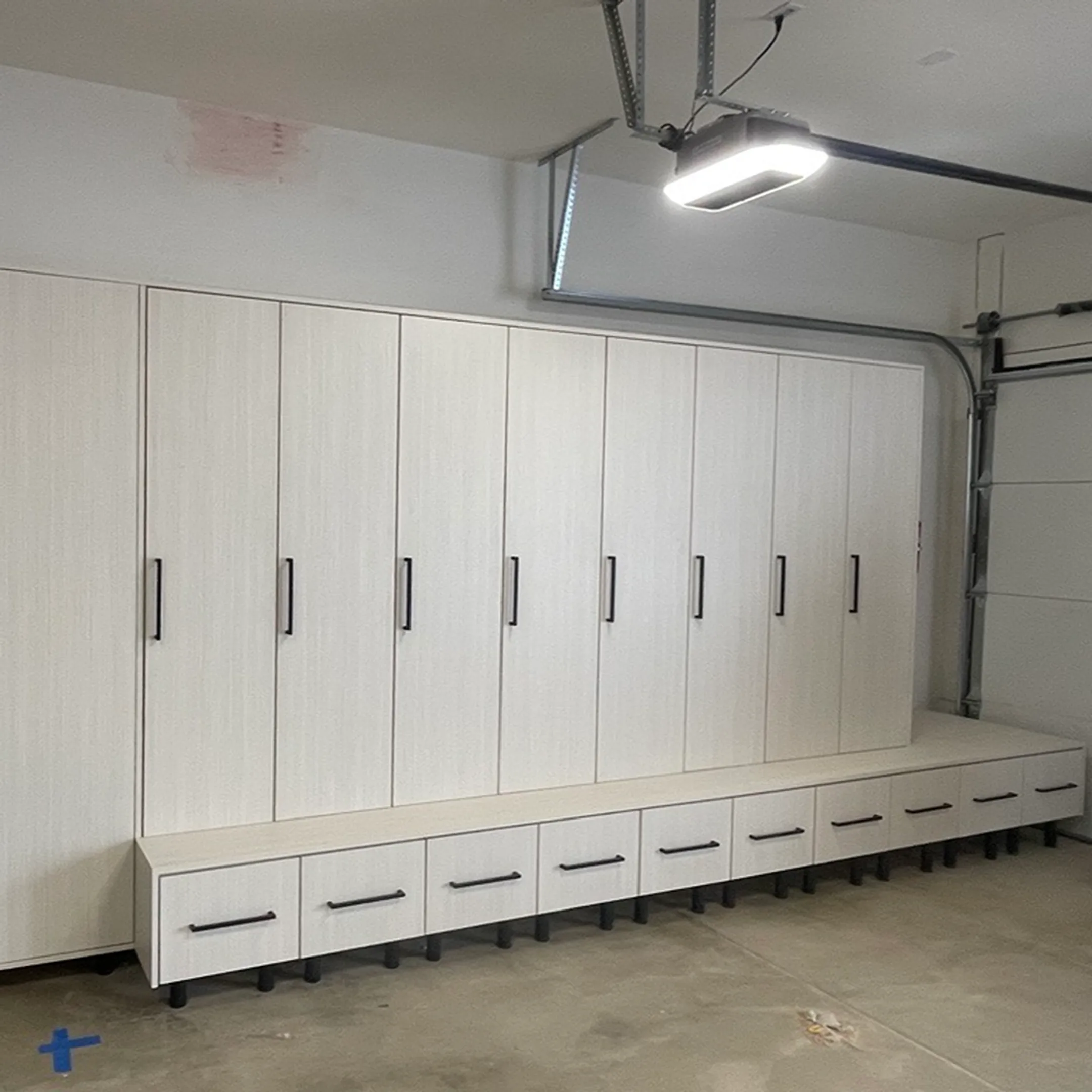 Installer fitting custom built-in cabinets in a home