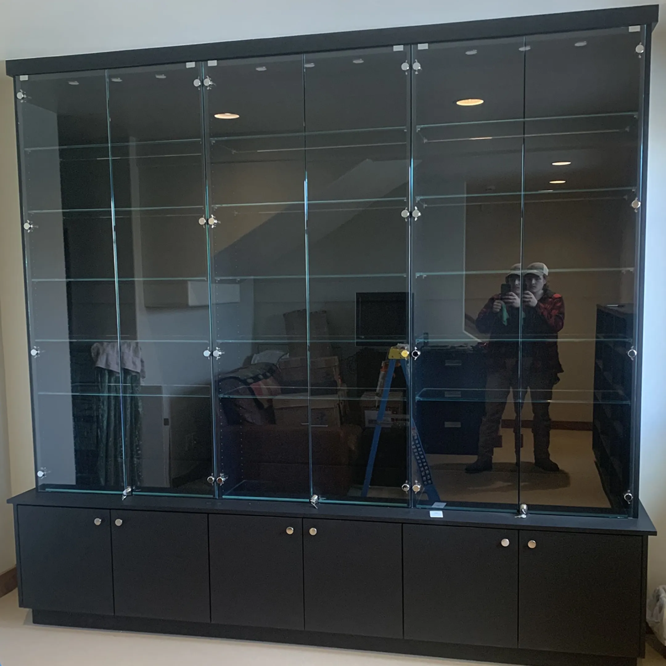 Designer reviewing custom storage plans with homeowner
