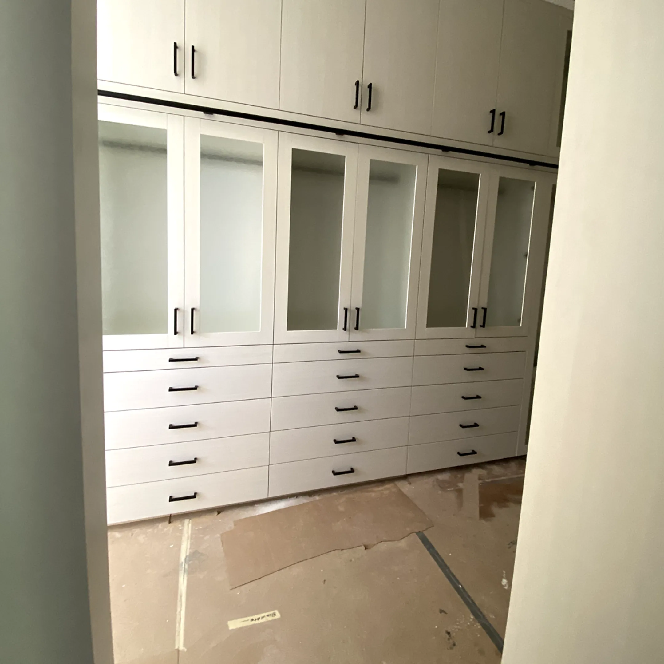 Installer fitting custom storage cabinets