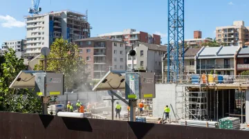 Construction site noise monitoring equipment positioned near urban residential receptor location