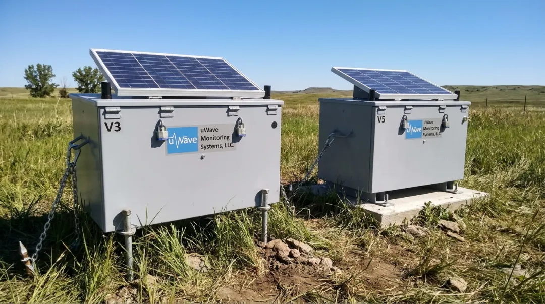 uWave V3 and V5 remote monitoring enclosures installed outdoors with solar panels