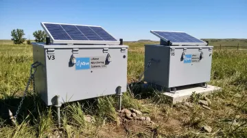 uWave V3 and V5 remote monitoring enclosures installed outdoors with solar panels