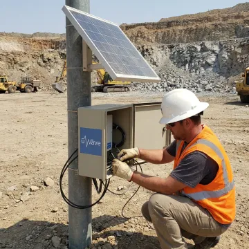 Technician setting up mining monitoring equipment