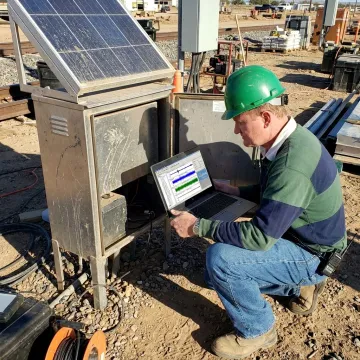 Engineer reviewing cloud-based monitoring data