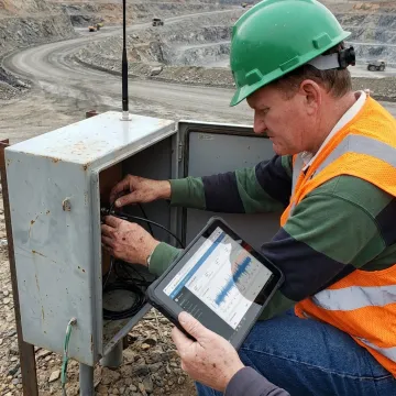 Technician configuring a remote mining monitoring system