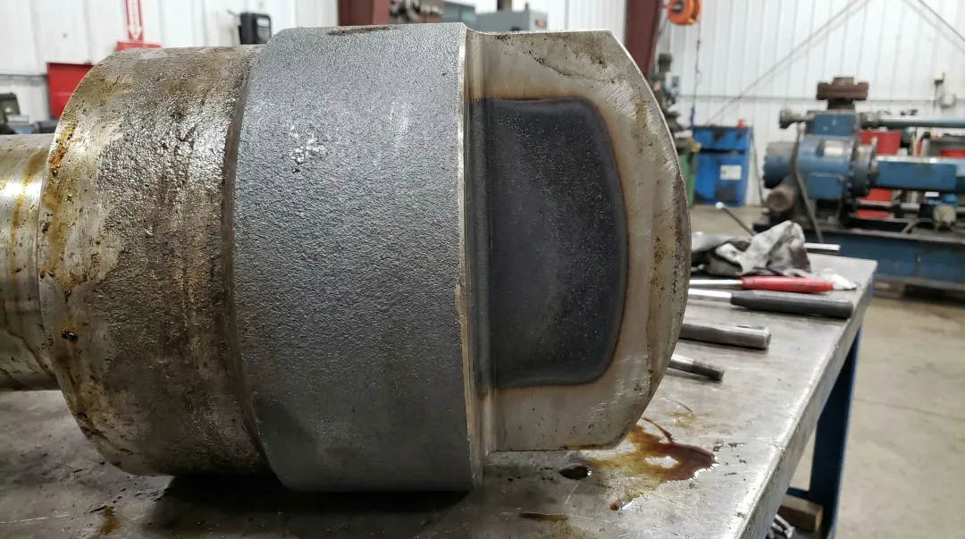 Boronized steel pump cylinder component showing diffusion coating cross-section surface treatment