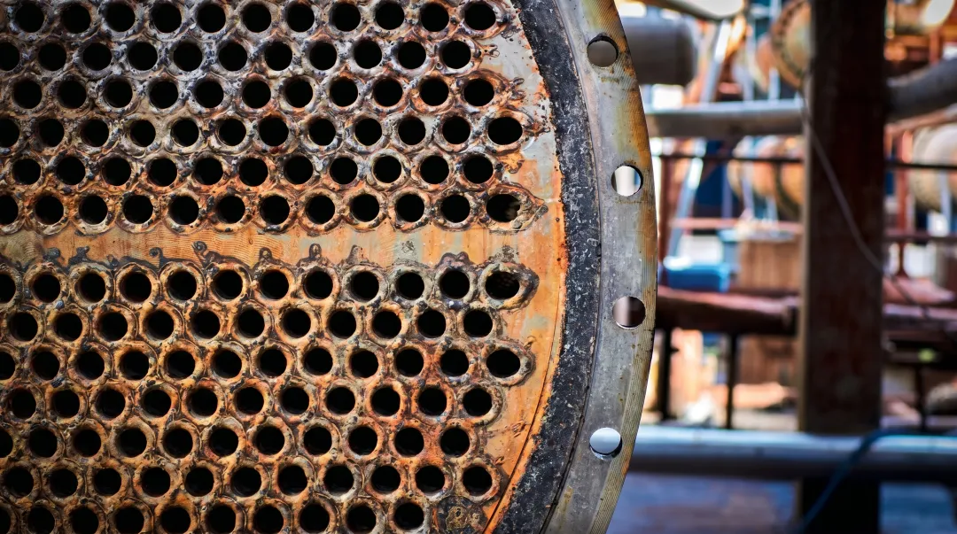 Heat exchanger tubes showing corrosion damage from high-temperature chemical exposure
