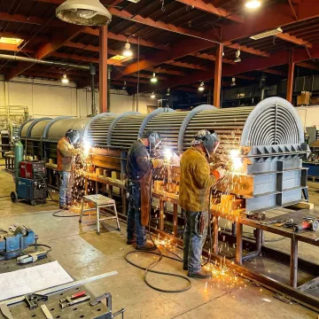 Custom heat exchanger fabrication and design by VaporKote technicians in an industrial facility