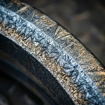 Close-up of a boronized metal pump impeller showing a hardened protective coating surface