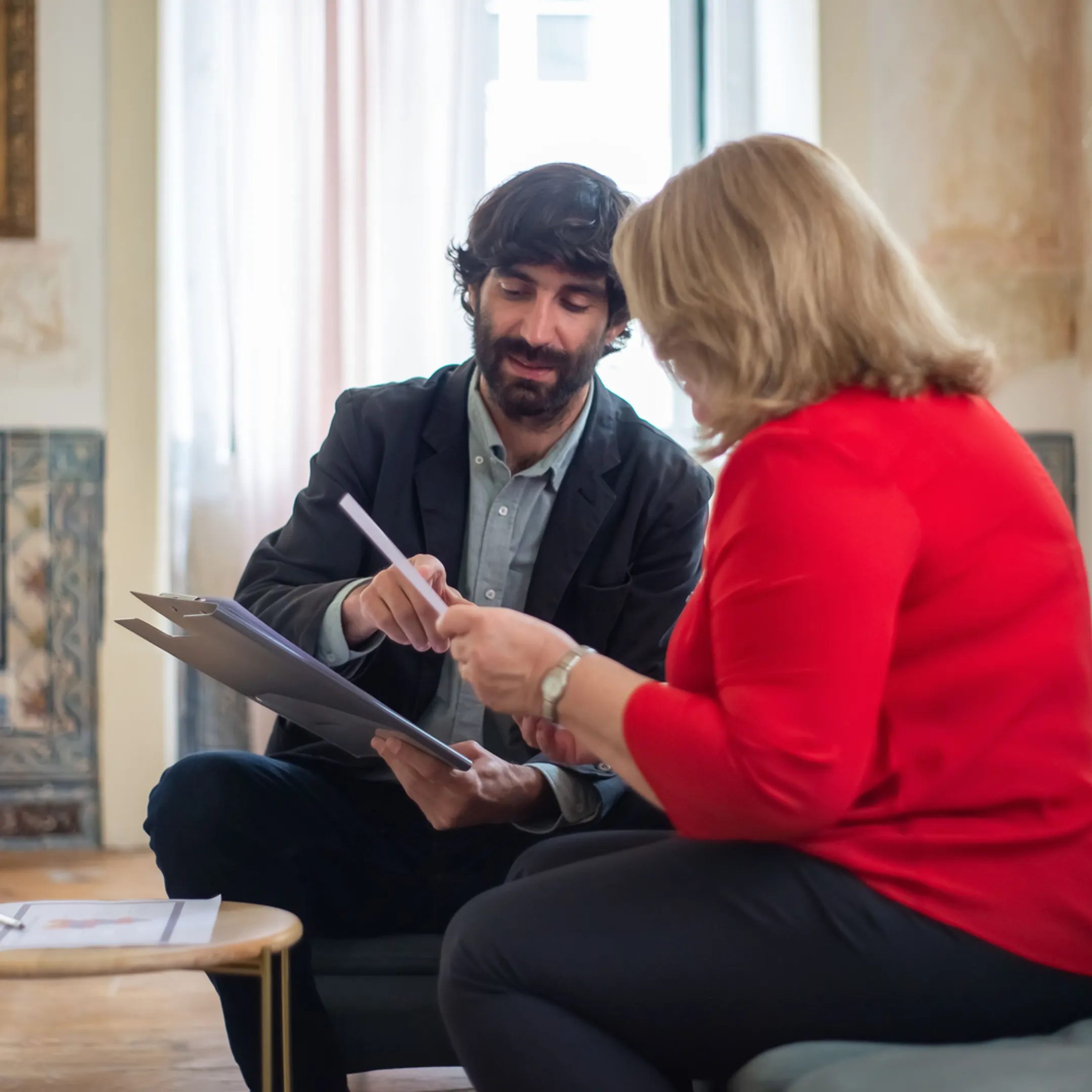 Senior financial operator reviewing startup forecasts with an entrepreneur