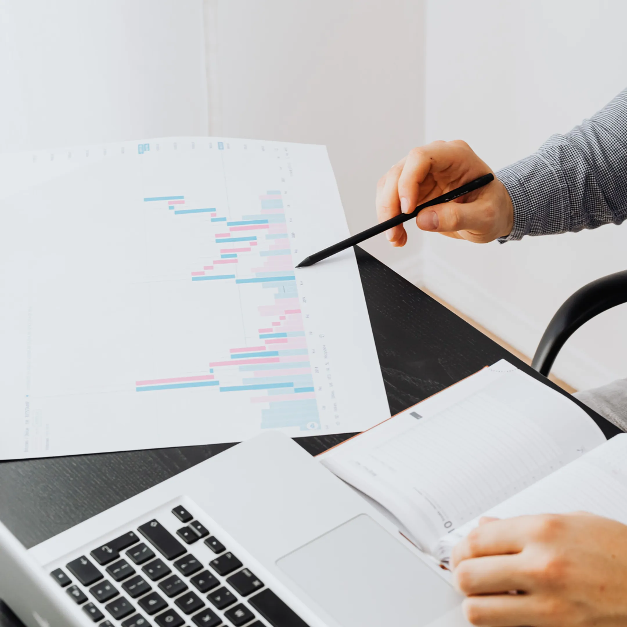Senior finance expert reviewing business reports with a leadership team