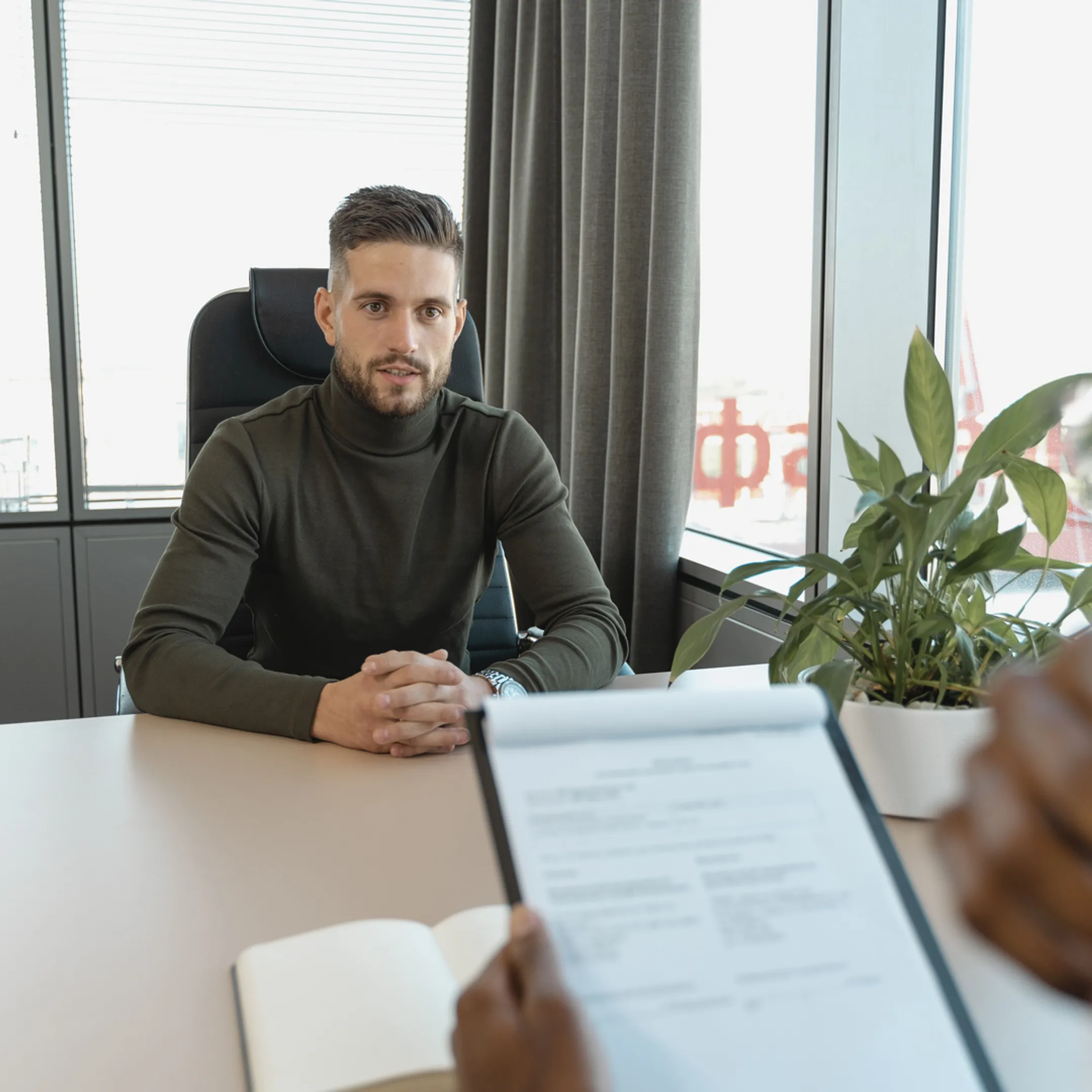Senior finance operator reviewing company financial reports with founders