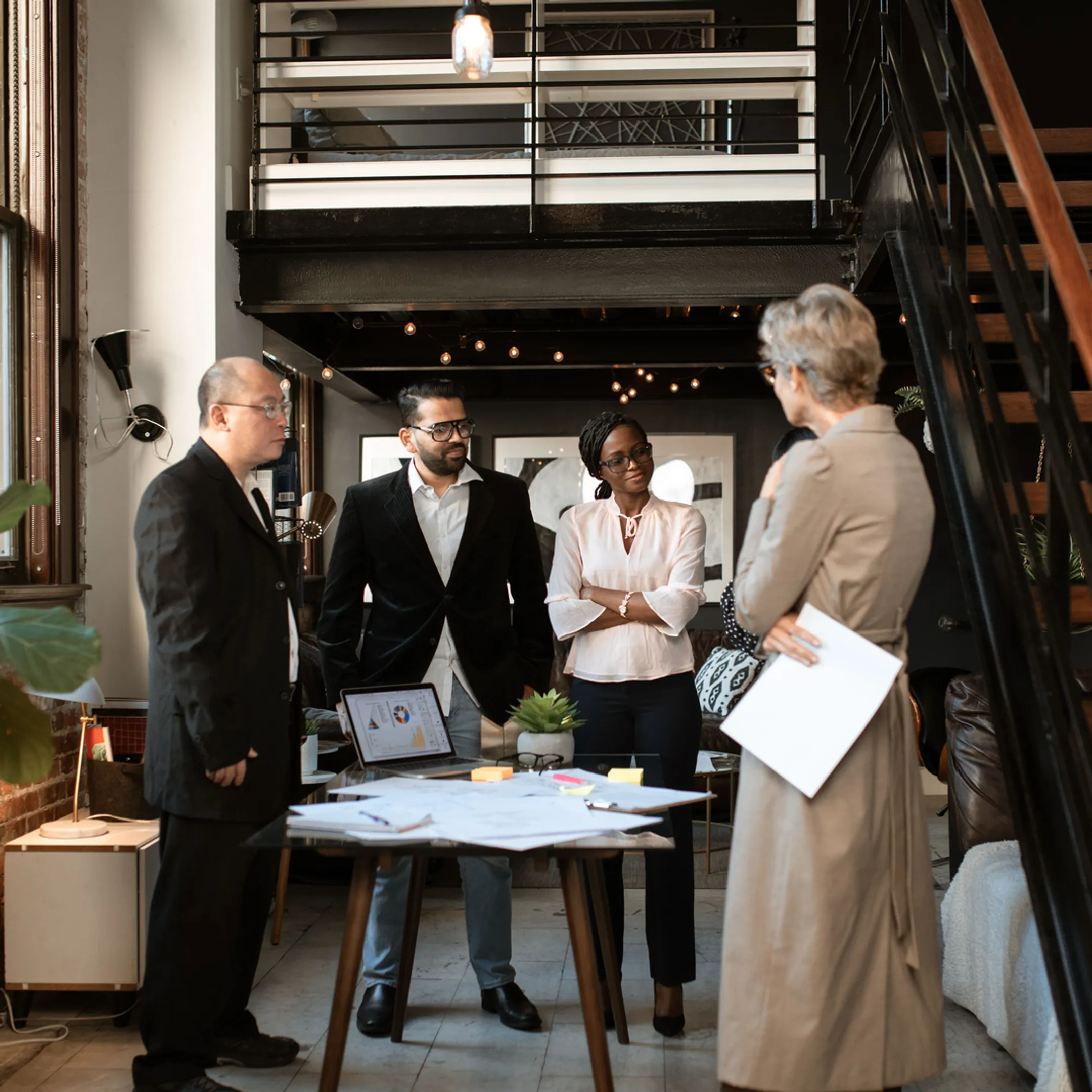Senior business consultants collaborating with founders around a conference table