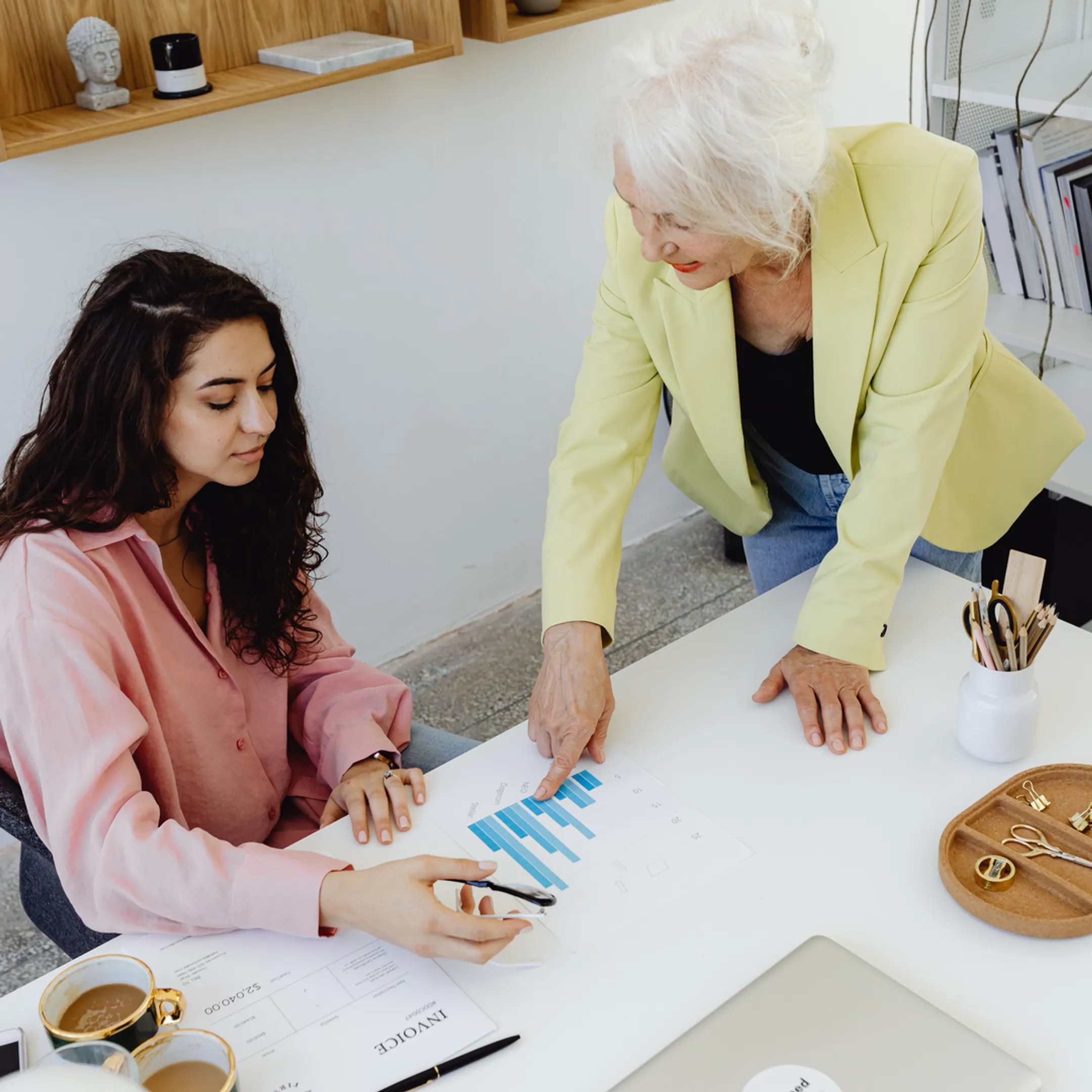 Senior fractional CFO reviewing startup financial reports with founders