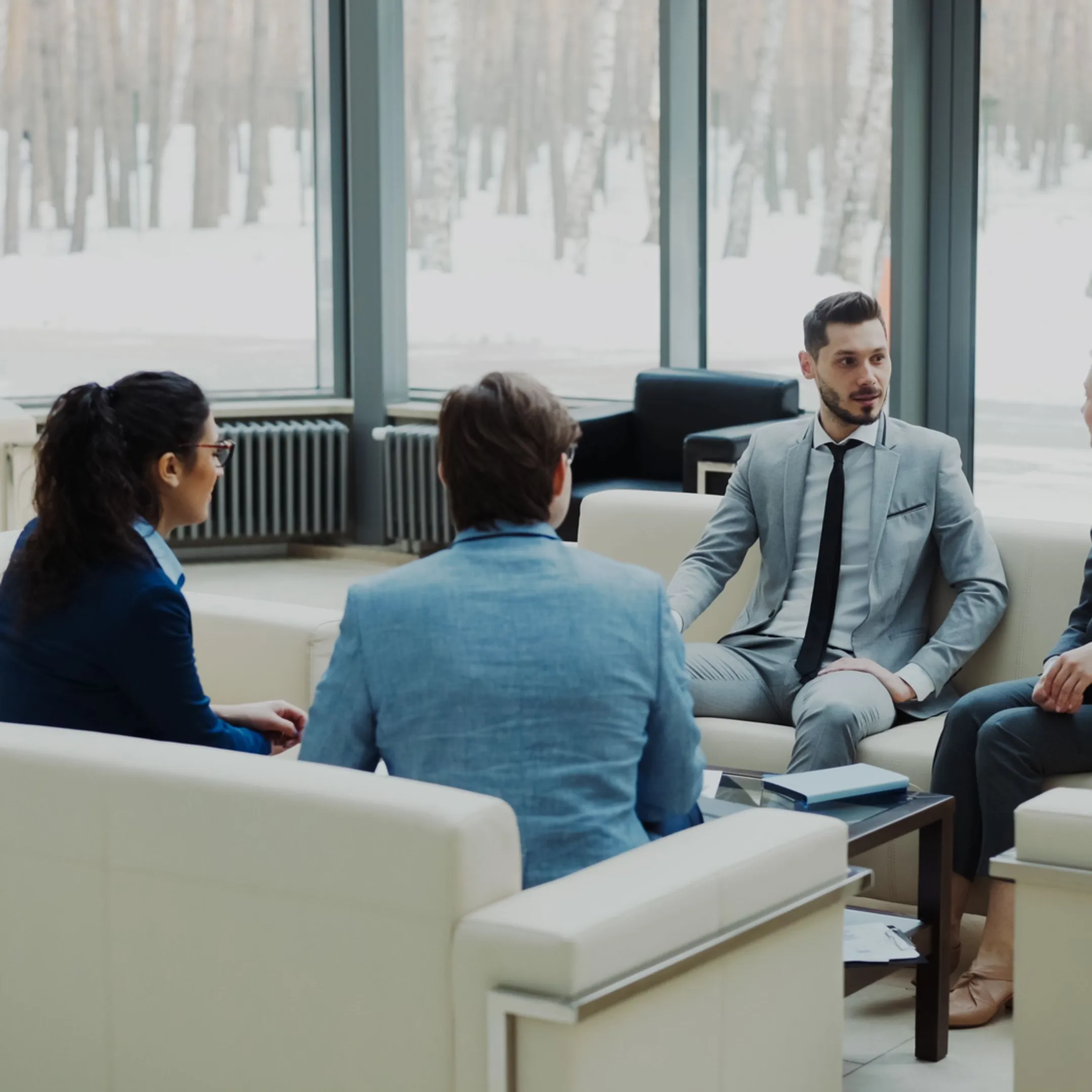 Senior startup finance operator reviewing financial reports with founders