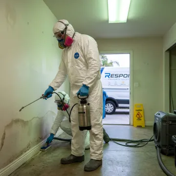 Biohazard cleanup team decontaminating an affected room
