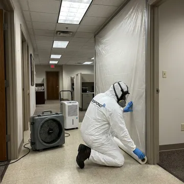 Biohazard cleanup technician preparing a commercial room