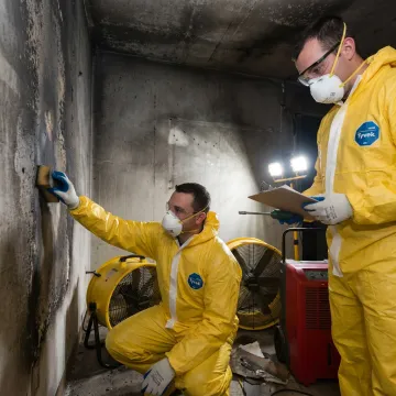 Restoration crew inspecting water and fire damage