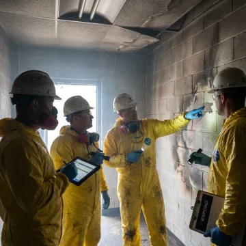 Commercial fire restoration crew inspecting smoke damage