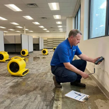 Technician documenting commercial water damage drying process