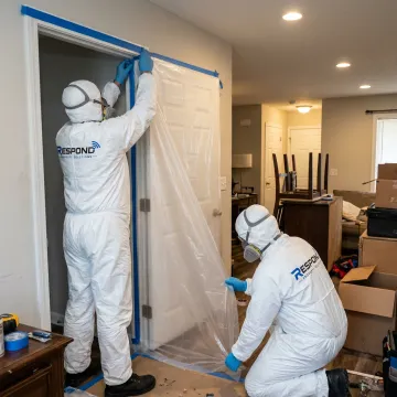 Biohazard cleanup crew preparing a controlled work area