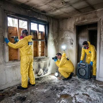 Technicians documenting fire damage restoration process