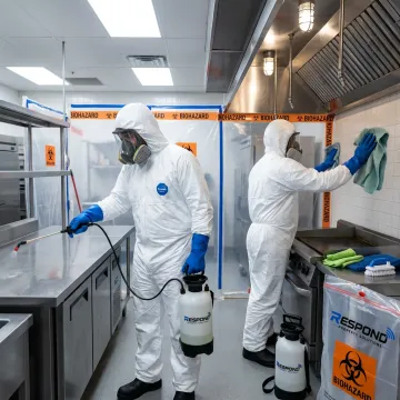 Technicians decontaminating a commercial facility