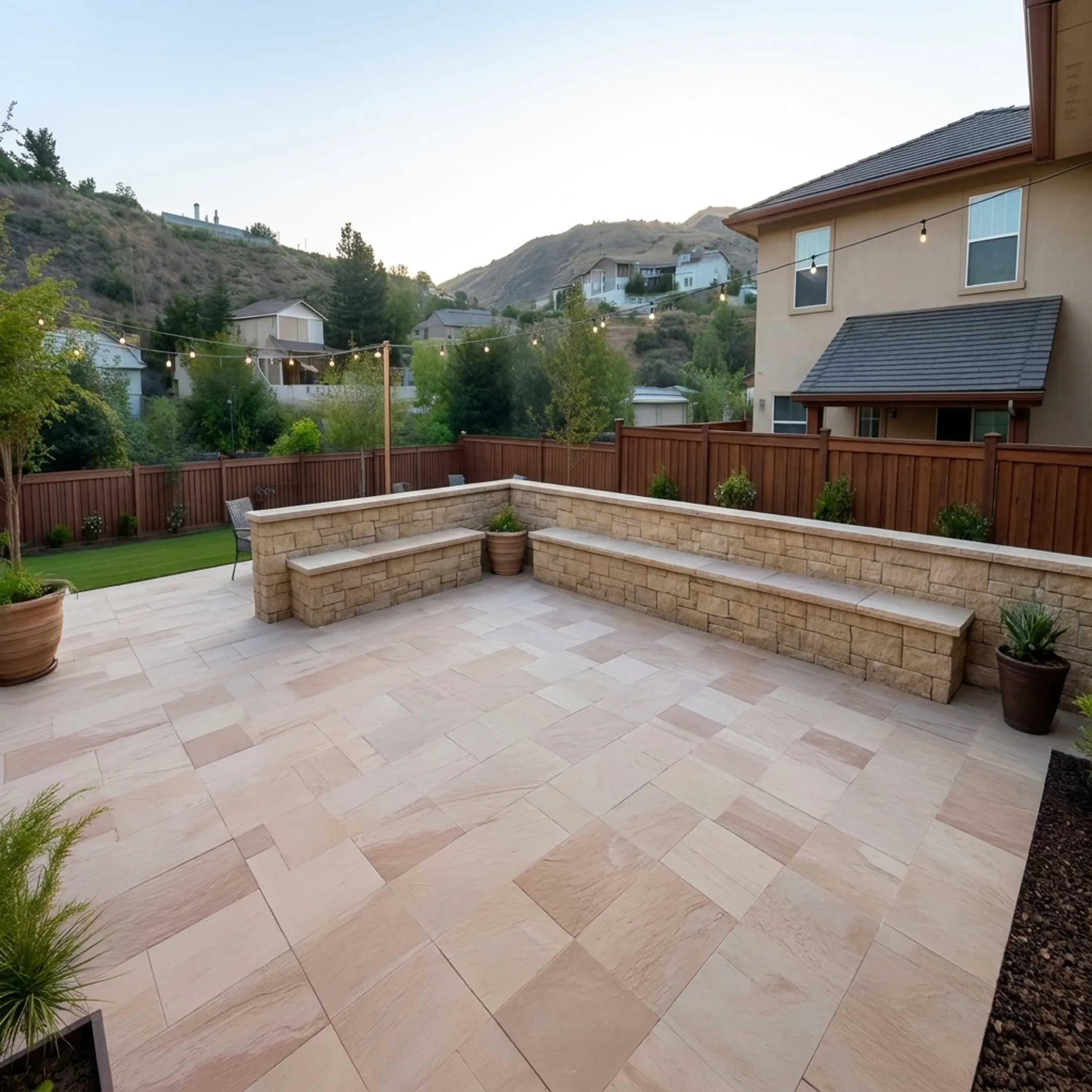Custom paver patio and retaining wall hardscaping in a backyard