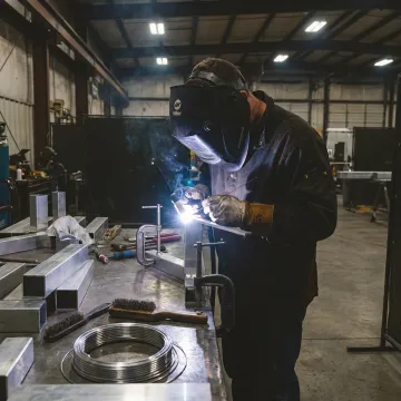 Certified aluminum welder working in fabrication shop