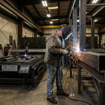 Custom metal fabrication shop with welding and formed steel parts