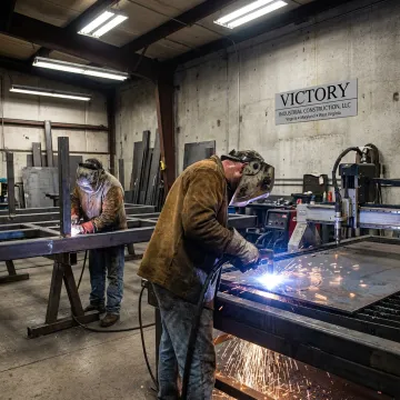 Custom metal fabrication shop with welding and steel parts