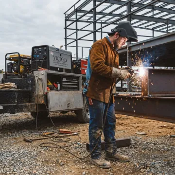 Mobile welder working on steel equipment at an industrial jobsite