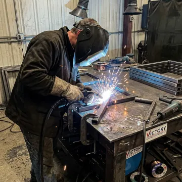 Industrial welder fabricating steel components