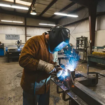 Industrial welder working on steel fabrication