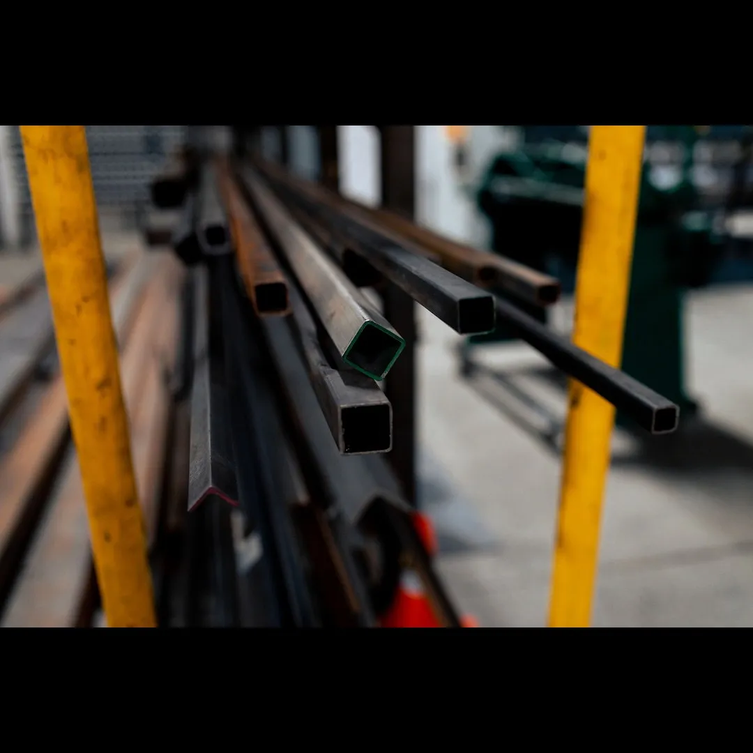 Fabricator welding an industrial ladder assembly