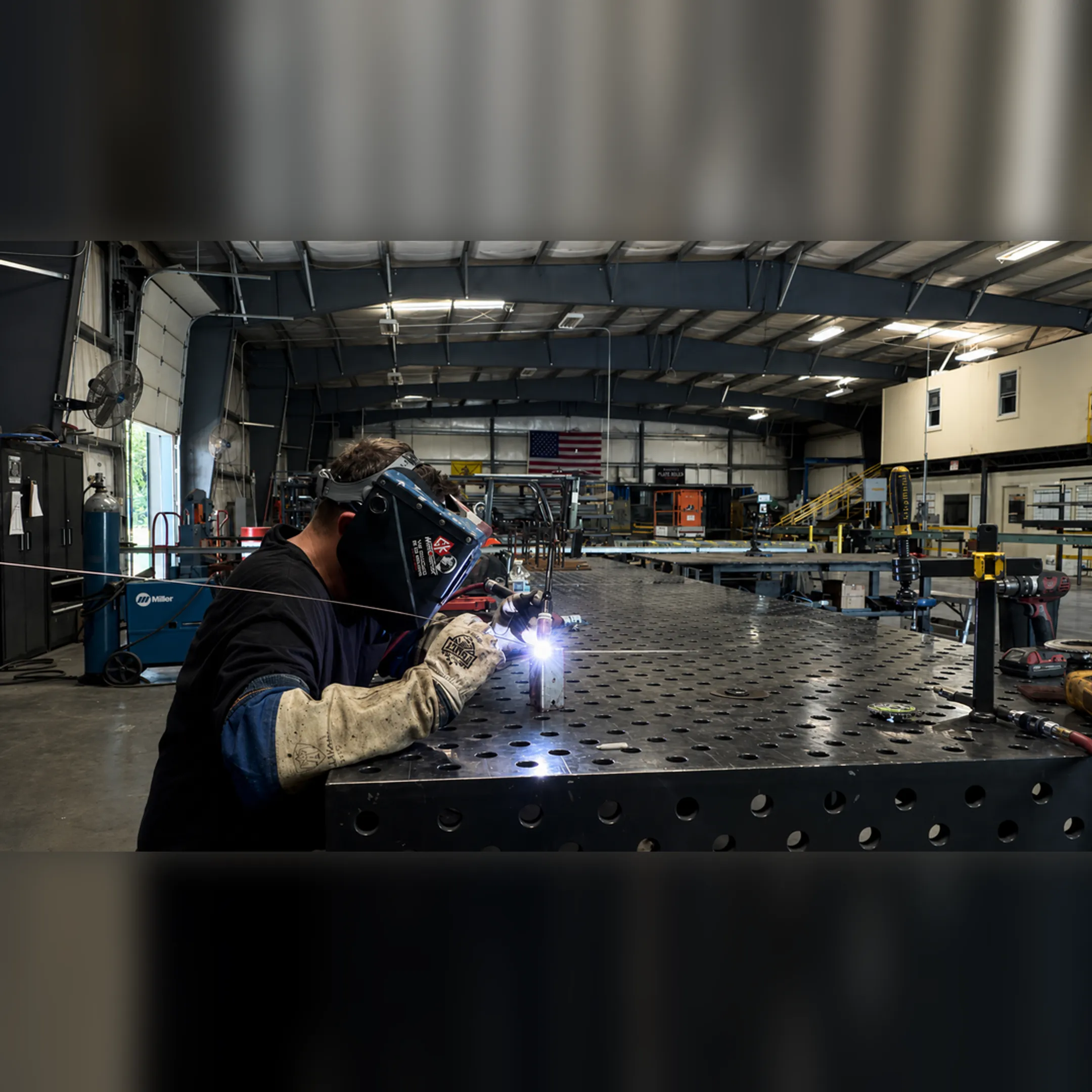 Industrial welder working on steel fabrication