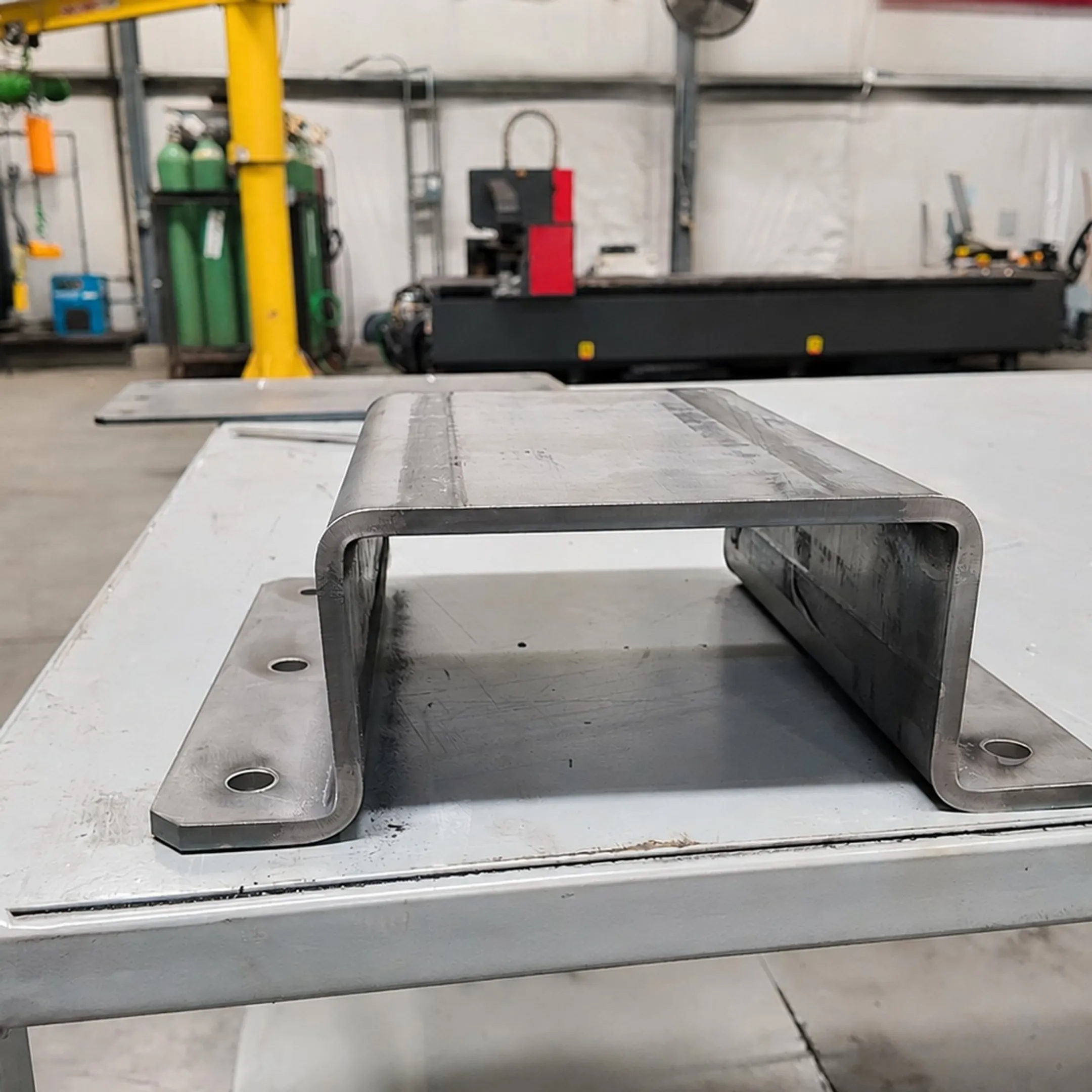 Fabricator welding an industrial ladder assembly