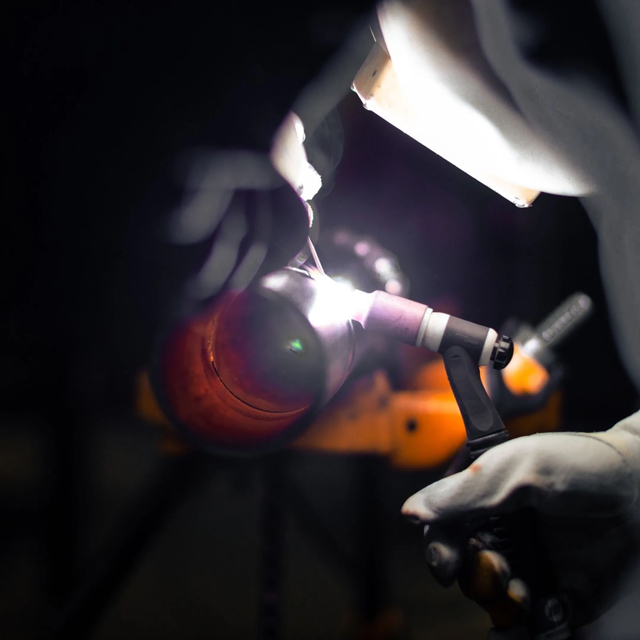 Fabricator reviewing CAD drawings near CNC equipment