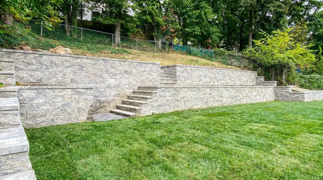 Segmental retaining wall with curved blocks on steep residential hillside site