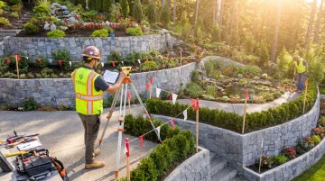 Hillside hardscape specialist assessing steep residential slope and drainage conditions