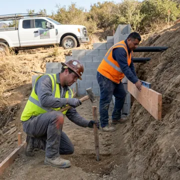 Crew building hillside hardscape steps
