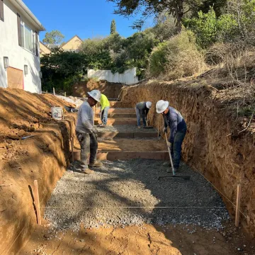 Hardscape crew preparing a stone patio base