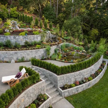 Custom retaining wall in a landscaped residential garden