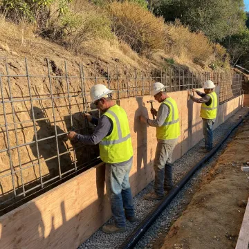 Engineered retaining wall construction on a hillside