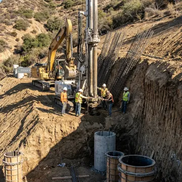 Deep foundation contractors drilling caissons on hillside property
