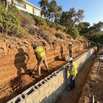 Reinforced earth retaining wall on hillside property